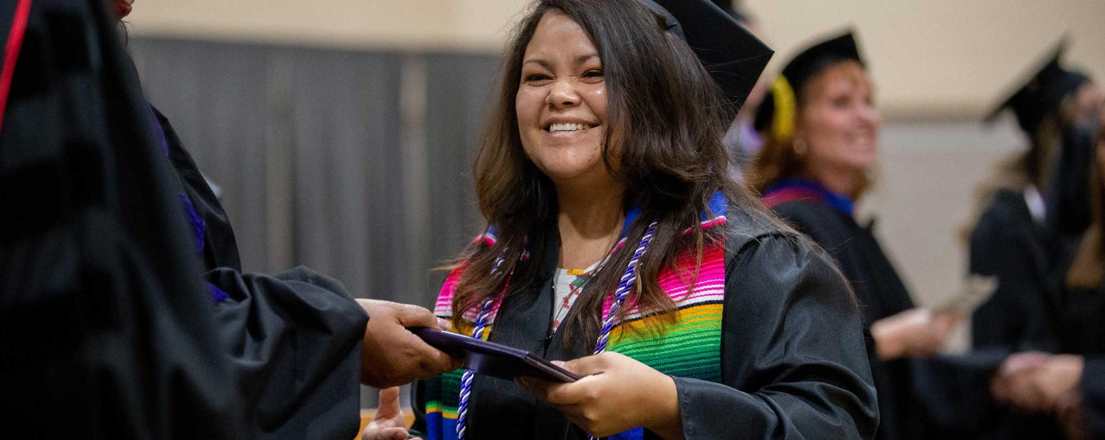 Smiling woman receiving diploma