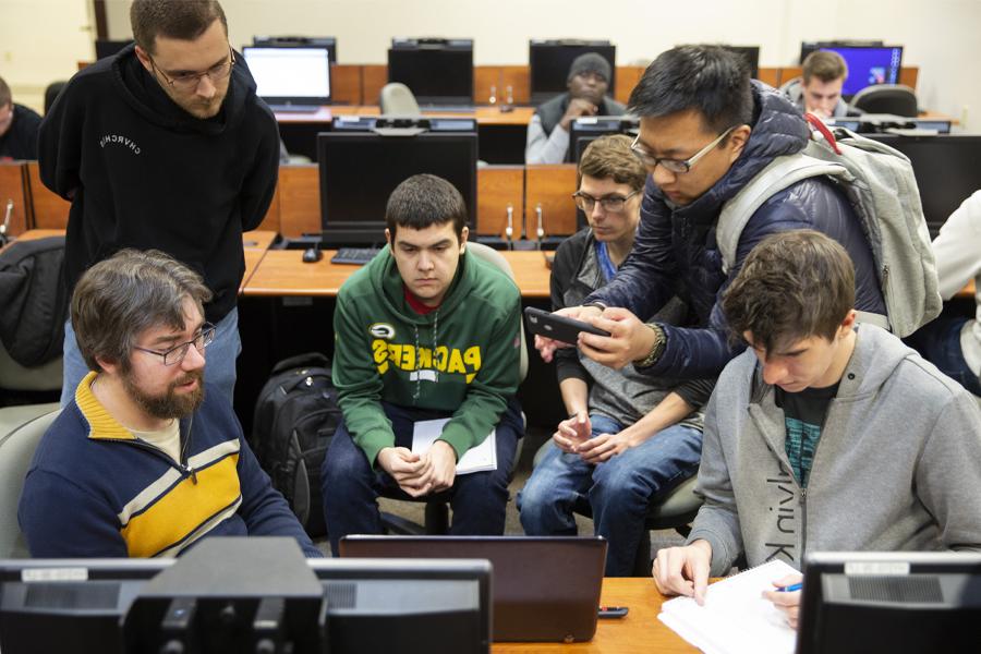 A group of students work together with a faculty member.