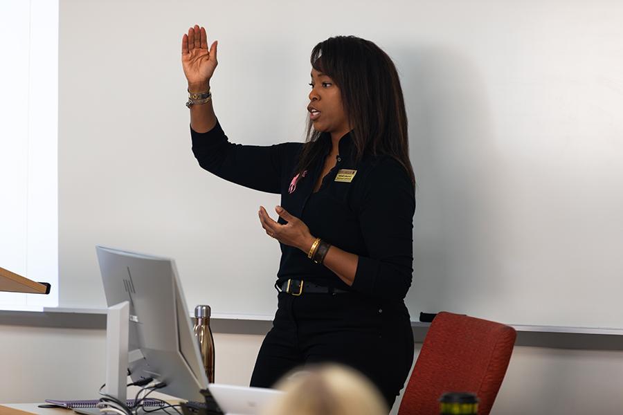 A faculty member speaks at the front of class.