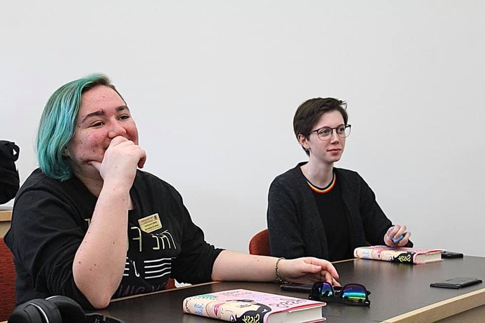 Two students in a class while reading Jacob Tobia's memoir. 