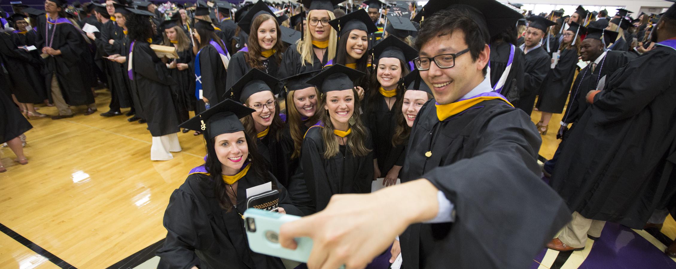 Students gather for a selfie at Commencement.