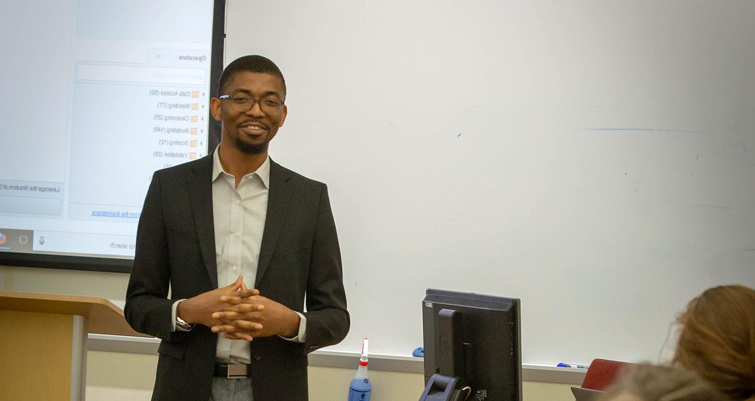 Assistant Professor Onochie Fan-Osuala addresses a classroom