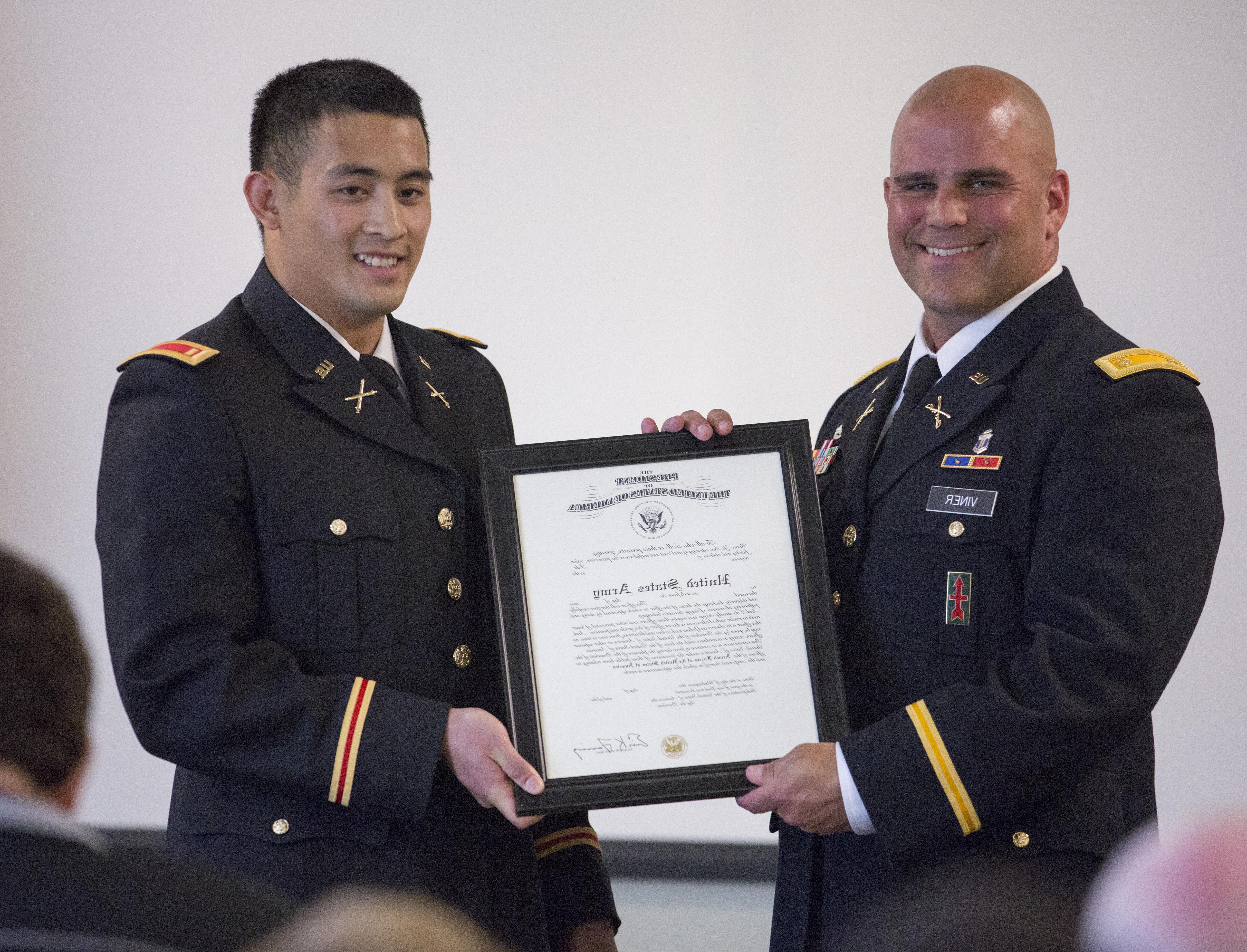 Student in uniform receiving a award