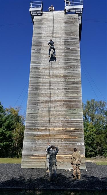 Student in uniform climbing a tower