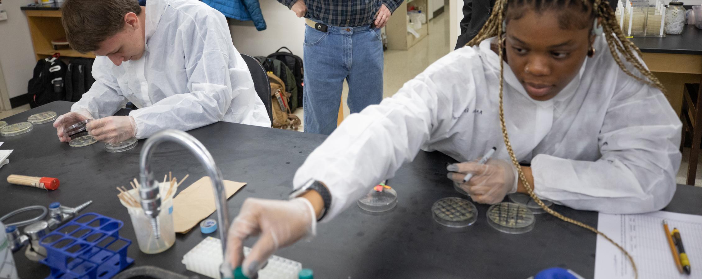 An international student works in a science lab.