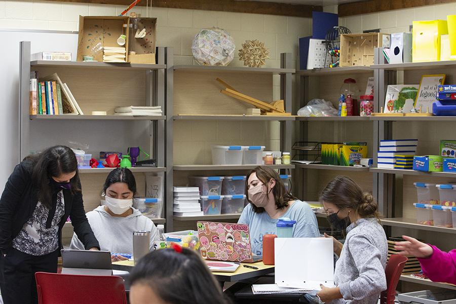 Ozgul Kartal teaches at a table with students.